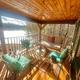 Interior overhead/loft view showing vaulted wood ceiling and main common area — useful to illustrate cabin/lodge interior space.