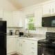 Kitchen with tiled backsplash and window in a Lost River RV Park cabin
