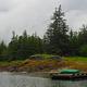 Berg Bay with a canoe on a float with cabin in the background and trees