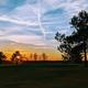 Sunset view over the course with silhouetted trees and sky — from the Membership page, provides an attractive scenic image of the resort grounds.
