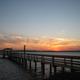 Long wooden pier extending into the river at sunset — strong scenic shot demonstrating the resort’s river access and waterfront atmosphere (from the property homepage/amenities).