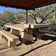 a stone picnic table in surrounding area outside the ramada