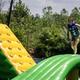 Indian Springs Campground & Water Park - Family enjoying the new Splash Springs Floating Water Park with water slide, beach area, and scenic fishing lakes in a serene forest setting. Perfect for camping, fishing, and water fun near Fort Wayne.