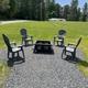 Close view of the outdoor firepit area with seating and gravel pad — highlights an on‑site communal/outdoor amenity for guests.