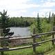 A view of the Au Sable River and a fence from the Au Sable Loop Day Use Area