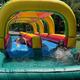 Inflatable water/slip-and-slide feature with participants in a grassy setting — highlights seasonal water activity offered at the campground (Gallery page).