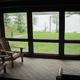 Screened porch view overlooking the lake — from the Rentals page, demonstrates lakeside setting and view from accommodations.