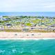 Oceanfront aerial showing beachfront campsites and resort land strip between ocean and interior — useful to illustrate beach access and beachfront site rows (from gallery page).