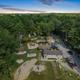 Twilight aerial of campground central area with playground and buildings (restrooms/office) — highlights on-site amenities and community spaces referenced on the site.