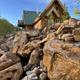 Hummingbird Cabin â log cabin with green roof perched above rocky canyon landscape at Zen Zion