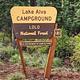 A photo of the campground entrance sign. It reads: Lake Alva Campground, Lolo National Forest, U.S. Department of Agriculture.