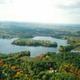 Aerial view showing lakes, islands and surrounding forest — good overall property/setting overview; file is from the campground's homepage gallery.