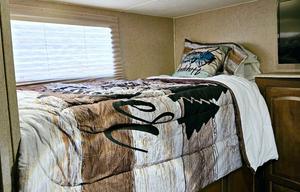 Large RV with outdoor kitchen, fireplace, and TVs