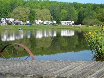 Foreground dock and pond with RVs visible across the water — good close scenic detail of the lake and recreation area (Gallery/Overview context).