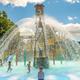 Close, wide shot of the water play structure and splashpad with active water features and slides — highlights the park's pool/waterpark amenity featured on the site.