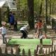 Shows an on-site family activity area (outdoor mini-golf) with RV visible in background; source page is the campground's Online Tour (home.html), supporting that this is a property facility photo.
