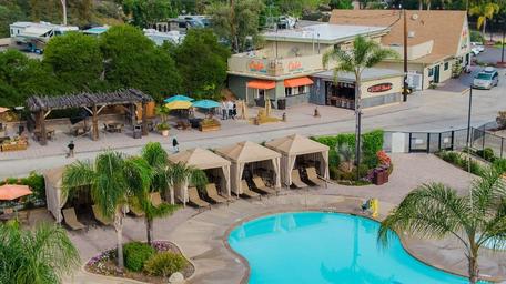 Aerial/overview image showing the campground's swimming pool area, cabanas and the plaza/office buildings — provides a broad layout view and is from the campground page imagery.