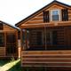 Exterior view of wooden rustic cabins on-site — good depiction of lodging available (from the campground 'Features & Facilities' / 'Rustic Cabins' pages).