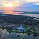 Aerial sunset view showing the full waterfront layout of the resort, docks, pool and RV pads — clearly an overview of The Tides property (source: gallery page).
