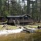 Virginia Lake Cabin below trees with water in front