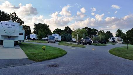 Ground-level view of paved roads and RV sites with parked trailers — good depiction of typical site appearance and driveway layout (sites.jpg).