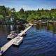 Aerial view of the campground's long dock and boats on the lake, showing shoreline development and waterfront activity — useful overview of marina and lakefront facilities (source page: site header/background).