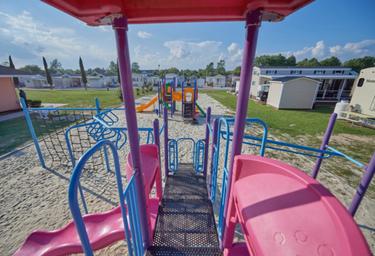 Playground view taken from on the play structure overlooking nearby RV sites — useful for families and shows on-site children’s play area (included in the resort photo set).