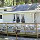 Exterior view of a trailer rental with deck and outdoor seating — illustrates the resort’s trailer accommodation options and appears on the homepage content.