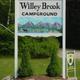 Entrance sign for Willey Brook Campground clearly identifies the property; from mainpage.html so confirms on-site signage and arrival area.