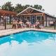 Pool area with fenced pool, lounging guests and adjacent buildings — illustrates onsite pool and social facilities, from the Mystic Quarry gallery.