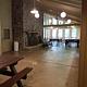 Inside of Clark Lake pavilion showing room layout with fireplace, windows, benches, and picnic tables.
