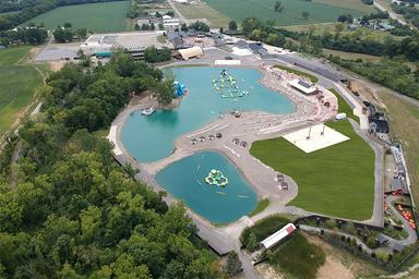 Large aerial of the resort’s water features and surrounding facilities — shows the main lagoon-style swim/waterpark and adjacent buildings matching the property’s amenities imagery (aerial-view.jpg).