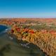 Aerial view along the shoreline showing docks, tree-lined campground and lakeshore — strong overview of property layout and waterfront (matches site homepage gallery context).