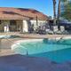 Clear photo of the resort pool, deck chairs and clubhouse building — shows on-site swimming facility and matches page context for resort amenities.