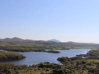 The Wichita Mountains line the horizon beyond the shore of Quanah Parker Lake.
