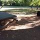 Shaded picnic table and grill.