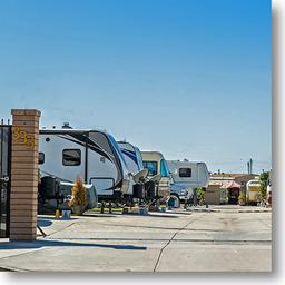 Perspective along a row of motorhomes with site marker '333' visible; shows paved pads, site layout and RV types — good representation of available spaces (used on the Space Rental page).