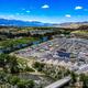 Aerial image focused on the grid of RV pads, roads and clubhouse with river and mountains in background — useful overview of site layout and amenities; appears on the main site.