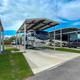 Covered RV parking row showing metal awnings and concrete pads — useful detail of covered site options advertised on the site.