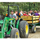 From the homepage gallery images: hayride photo with tractor and trailer of guests — demonstrates onsite activities/events and family-oriented amenities.