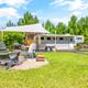 Gravel campsite with tent platform and picnic/fire area — clear view of a typical glamping pitch; comes from the property’s glamping gallery (87_tg2_5550).