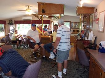 Interior view of a bar/lounge area with patrons — useful to show on-site amenities (Burnside Tavern / clubhouse) documented in the property gallery.
