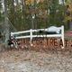 On-site seasonal display at the campground (fence with 'Trick or Treat' sign, tents and campground ground visible). Source page is the property listing, supporting that this image depicts the Brown County KOA grounds and holiday decoration.