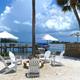 Waterfront seating and firepit area facing the bay with docks in background — highlights waterfront amenities and guest gathering space (shown on homepage/amenities).