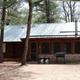 Front view of a numbered cabin with picnic table and grill — clear cabin exterior representative of the resort's lodging (appears on property pages).