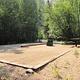 Campsite, fire pit, picnic table, green foliage