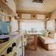 Interior of a restored vintage trailer, showing the kitchenette and seating—demonstrates accommodation interior and amenities (source page: homepage).