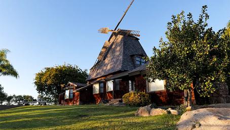 Distinctive windmill/clubhouse building on a grassy rise — a recognizable on-site landmark and part of the property’s character.