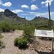 A wayside sign stands at the beginning of the Alamo Canyon trail.