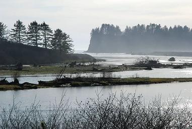 The mouth of the Quillayute River at Rialto Beach. Large sea stacks rise just offshore.